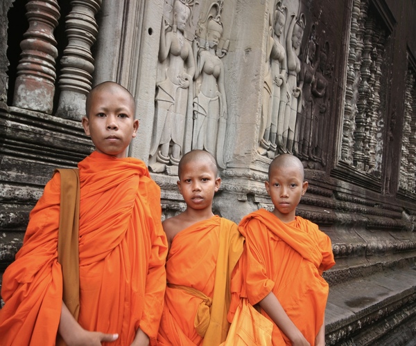 Cambodian monks pose in the grounds of Angkor