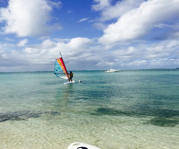 Windsurfing on the clear blue waters in Mauritius. 